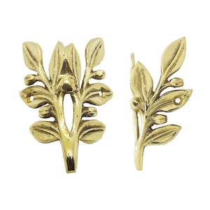 May include: Two brass-colored decorative leaf-shaped hardware pieces. Each piece features a detailed design of leaves and buds, with mounting holes for attachment. The hardware has a shiny, metallic finish, suitable for furniture or decorative projects.