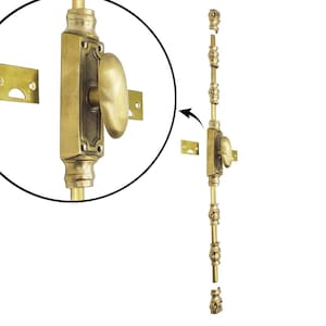 May include: A brass window sash lock with an oval handle and decorative detailing. The lock includes a long rod with decorative elements and two mounting plates. The close-up shows the handle and the lock's intricate design.