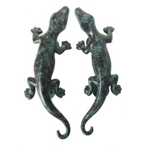 May include: A pair of green gecko door handles. The handles are made of metal and have a realistic gecko design.