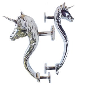 May include: Two silver-colored unicorn door handles. Each handle features a detailed unicorn head with a spiraled horn and a curved body. The handles are designed to be mounted on a door with the included hardware.