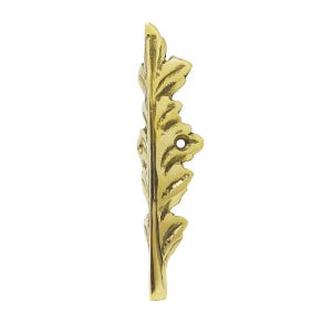 May include: A brass-colored, leaf-shaped decorative hardware piece. The hardware has a detailed, textured surface with a naturalistic leaf vein pattern. It features a single hole for mounting and is designed for furniture or decorative applications.