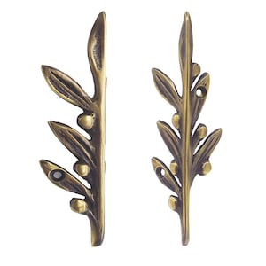 May include: Two bronze-coloured decorative leaf-shaped metal embellishments. Each piece features a detailed design of leaves and small, round accents, with holes for attachment. The metal has a vintage, antique finish.