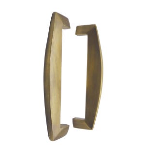 May include: Two brass-toned door pulls with a curved, rectangular design. The pulls have a warm, metallic finish and are set against a white background. The handles are designed for easy gripping and add a touch of elegance.