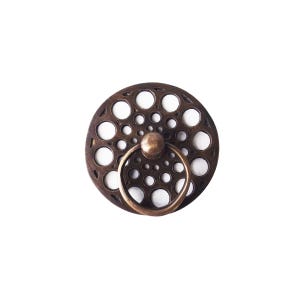 May include: A circular cabinet pull in a bronze finish, featuring a pattern of small holes. A matching ring handle is attached to the centre. The hardware is set against a white background.