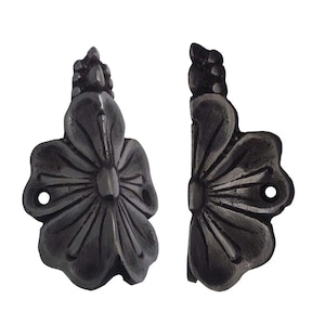 May include: Two dark gray, cast iron flower-shaped cabinet pulls. Each pull features a detailed floral design with a central flower and a decorative top. The pulls have pre-drilled holes for easy installation.