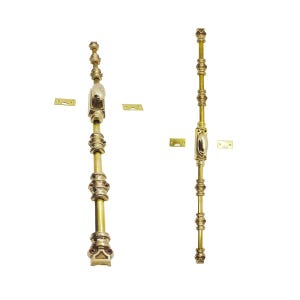 May include: Two ornate brass door bolts with decorative detailing. Each bolt features a central oval handle, multiple decorative rings, and mounting plates. The bolts are vertically oriented against a white background.