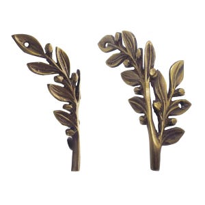 May include: Two antique bronze-coloured decorative leaf accents. Each leaf has detailed veining and small berry-like accents. The leaves are slightly curved and have a small hole for mounting. Ideal for furniture or craft projects.