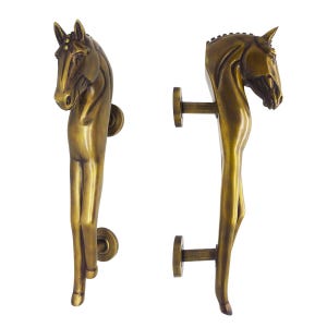 May include: Two bronze-colored door handles, each shaped like a horse. The handles feature a detailed horse head and body, with a circular base and a horizontal bar for mounting. The handles are set against a white background.