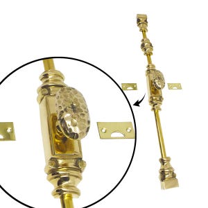 May include: A polished brass window sash lock with a textured, oval handle. The lock features a long, slender design with decorative detailing and includes two small, rectangular strike plates. The hardware is shown against a white background.