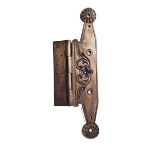 May include: A decorative brass hinge with ornate floral designs and a rounded top and bottom. The hinge is closed and ready to be installed.