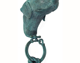 May include: A green metal door knocker shaped like a dog's head with a rope ring.