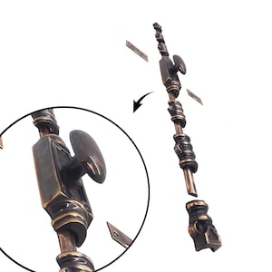 May include: A bronze-toned window sash lock with a decorative design. The lock features a knob and a series of ornate details along its length. The image includes a close-up view of the lock's knob and a diagram showing how the lock is assembled.