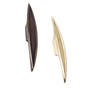 May include: Two cabinet pulls, one in a brushed brass finish and one in a dark bronze finish. Both pulls are shaped like a long, narrow leaf.