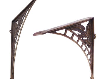 May include: A pair of ornate brass shelf brackets with a decorative leaf design. The brackets are made of solid brass and have a traditional, vintage style.