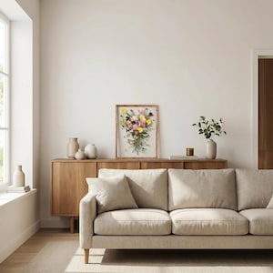 May include: A rectangular wooden frame containing a pressed floral arrangement featuring a variety of colorful flowers including yellow, pink, and purple blossoms mixed with green foliage, displayed against a white background within the frame.