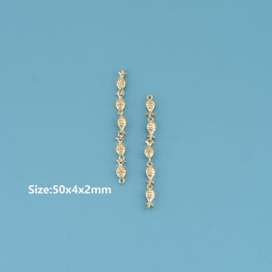 May include: Two gold-colored, dangling earring components. Each component is a chain of connected decorative elements, including star and teardrop shapes. The text "Size: 50x4x2mm" is visible in the image.