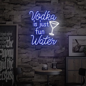 May include: A neon sign displaying the phrase "Vodka is just fun Water" in blue script, with a white martini glass icon. The sign is mounted on a textured brick wall, with a small table and bar accessories below.