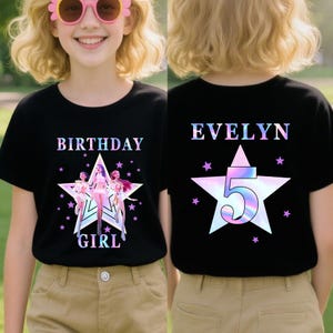 May include: A white ceramic mug with a black handle and the text "But First, Coffee" in a black, handwritten-style font. The mug is on a white surface.