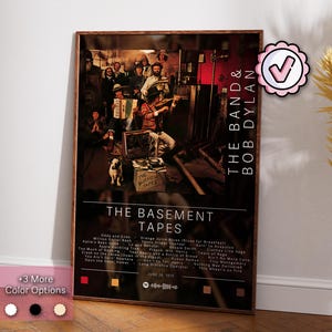 May include: A vintage poster for The Band and Bob Dylan's "The Basement Tapes" album. The poster features a photo of the band members in a dimly lit room, with Bob Dylan standing in the center. The album title is printed in large, bold letters at the bottom of the poster, along with a list of the songs included on the album.