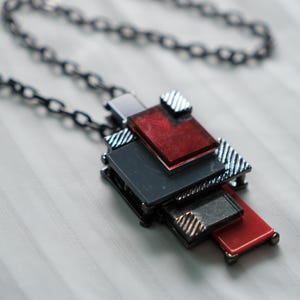 Geometric Industrial Style Pendant Necklace With Red And Black Layered Metal Design On Gunmetal Chain For Modern Statement Fashion