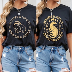 May include: Two black t-shirts with gold-colored graphics. One shirt features a badger with the words "Patience & Loyalty, Kindness & Justice." The other shirt has a weasel with the words "Patience & Justice, Dedication & Loyalty."