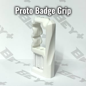 May include: A white Proto Badge Grip accessory featuring a vertical, angular frame with a textured, wavy side profile and a rectangular base section. The object is displayed against a white background with the text Proto Badge Grip visible.