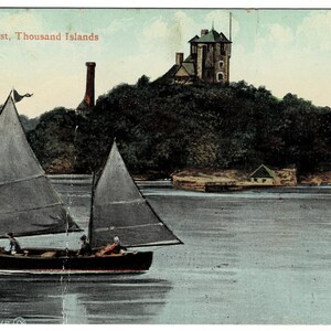 May include: Vintage postcard featuring a sailboat on a lake with a castle on an island in the background. The postcard is titled "Castle Rest, Thousand Islands." The image has a faded, aged appearance, with muted colors.