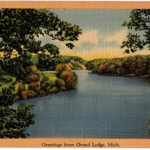 May include: A vintage postcard featuring a scenic view of a river winding through a landscape with dense green trees and a light-colored cliff in the distance. The bottom border contains the text Greetings from Grand Ledge, Mich. in black font.