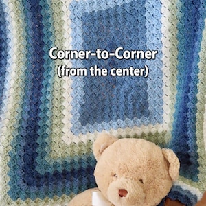 May include: A handmade, corner-to-corner crochet blanket in shades of blue, white, and green. The blanket is draped over a chair and a tan teddy bear with a white bow is resting on the chair. The text "Corner-to-Corner (from the center)" is visible.
