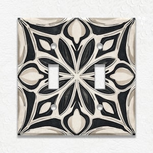 May include: A white ceramic mug with a black handle and the text "But First, Coffee" in a bold, black font. The mug is set against a blurred background, suggesting a cozy setting.