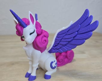 May include: A white and purple unicorn figurine with a horn, wings, and a curly tail. The unicorn has pink hair and purple hooves. A crescent moon is on its flank. The figurine is on a wooden surface.
