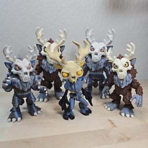 May include: Five collectible figures featuring creature designs with skull-like heads, large antlers, and fur-covered bodies. The figures display varied color schemes including shades of brown, grey, and blue, with yellow or orange eyes.