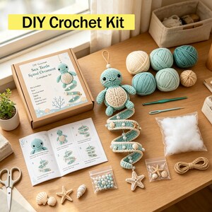 May include: A DIY crochet kit for a sea turtle spiral ornament, including a cardboard box with instructions, a finished crocheted turtle, multiple balls of teal and cream yarn, a crochet hook, a needle, stuffing, beads, and small seashells.