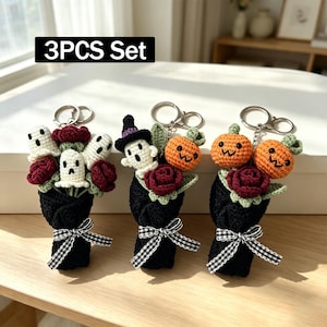 May include: A 3PCS Set of three crochet keychains featuring bouquets wrapped in black yarn with black and white gingham bows. The bouquets include dark red roses, white ghosts, orange pumpkins, and a ghost wearing a purple witch hat.