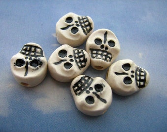 4 Tiny Skull Beads (flat white) - CB583