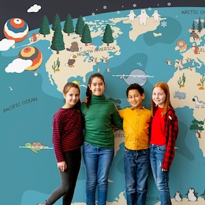 May include: Four children stand in front of a large world map mural. The map is a light blue color and features cartoon illustrations of animals and landmarks. The children are wearing casual clothing, including jeans and sweaters.