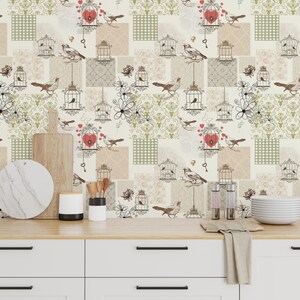 May include: A decorative wallpaper with a patchwork design featuring birds, birdcages, keys, and heart-shaped lockets. The color palette includes beige, cream, and light green, with black line drawings. The wallpaper has a vintage, romantic theme.