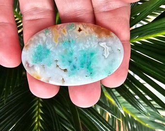 Plume agate oval with seafoam green mineral formations in an oval cabochon for jewelry making