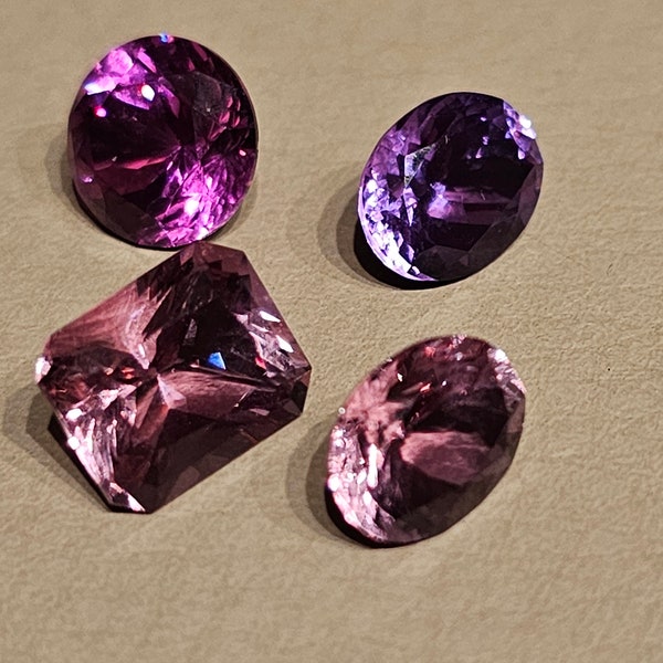 Assorted Faceted Gemstone Collection including pink spinel, pink sapphire, amethyst, and manmade Alexandrite