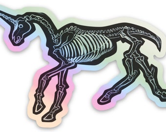 May include: A holographic sticker of a unicorn skeleton in a rainbow gradient. The unicorn is running with its head turned to the side and its horn pointing forward.