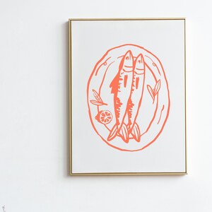 May include: A framed print of a stylized illustration of two fish on a plate with a lemon slice and leaves. The illustration is in a coral pink color.