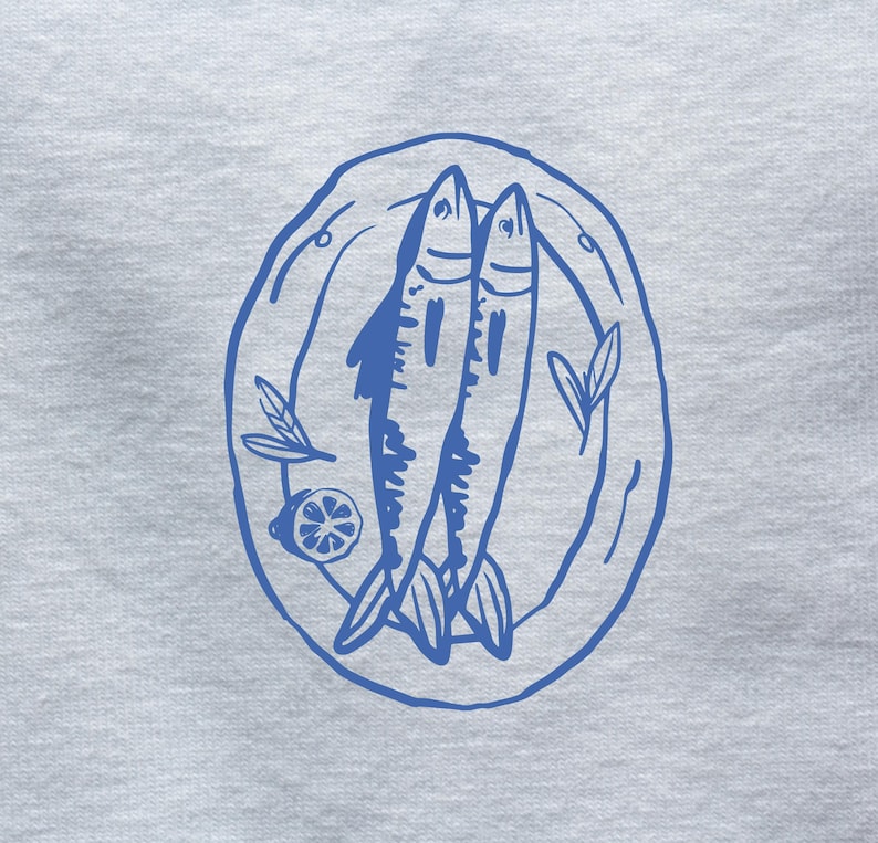 May include: A blue line drawing of two fish on a plate with a lemon wedge and a sprig of greenery.