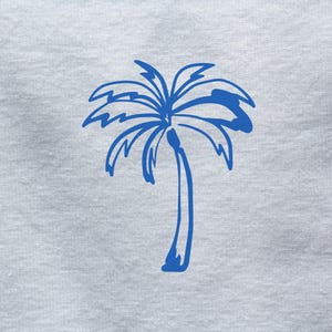 May include: A blue palm tree illustration on a white background.