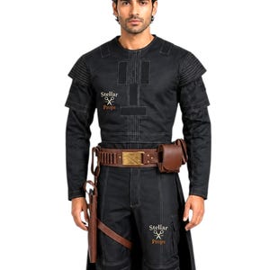 May include: Black costume with white stitching, featuring a long-sleeved top, pants, and a long coat. The costume includes a brown belt with a gold buckle, a holster, and a pouch. The text "Stellar Props" is visible on the costume.