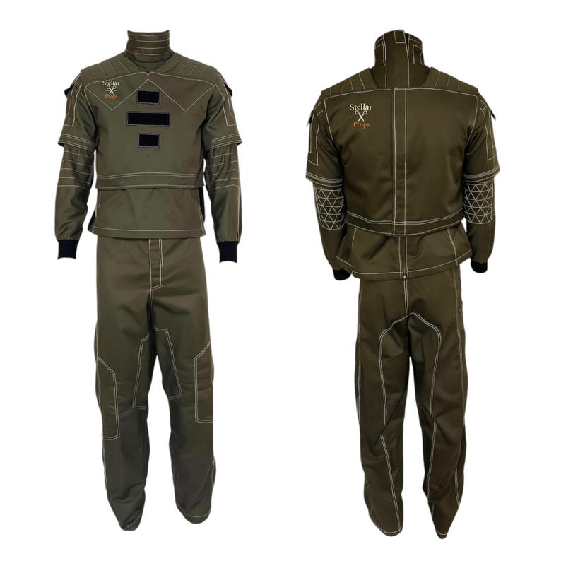 May include: Two-piece olive green tactical suit with white stitching and black cuffs. The jacket has a high collar, patches, and the text "Stellar Props". The pants have reinforced knee panels. The suit is displayed from the front and back.