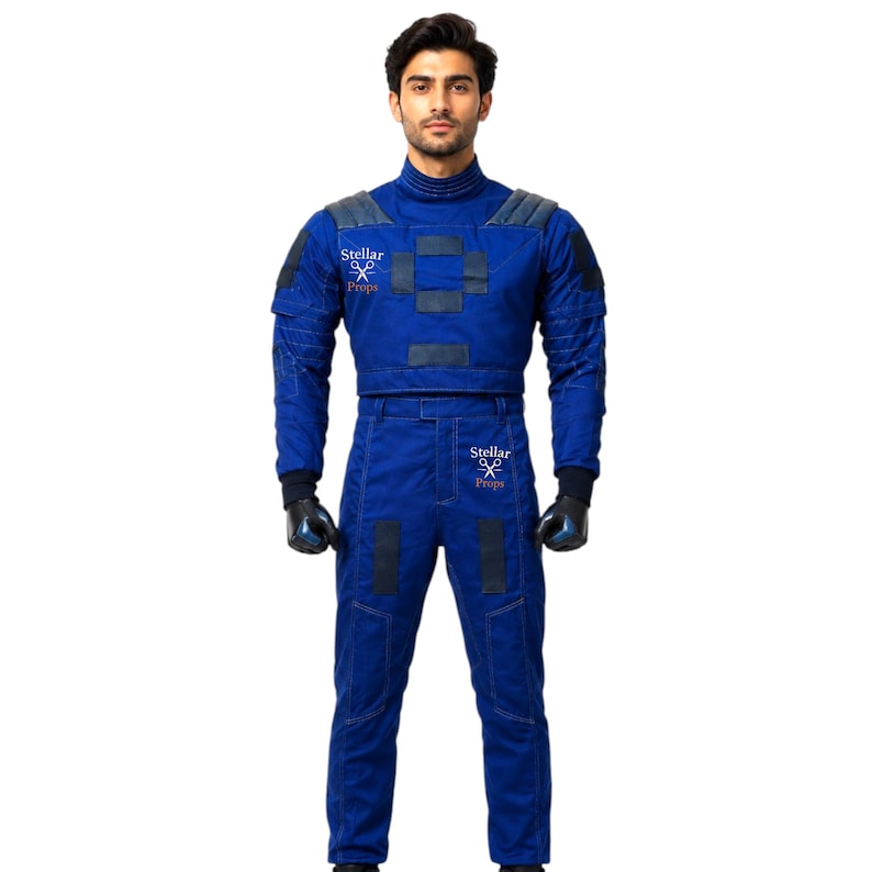 May include: A blue jumpsuit with black accents and the text "Stellar Props" on the chest and arm. The jumpsuit has a high collar, padded shoulders, and black gloves. The outfit is designed for a costume or cosplay.