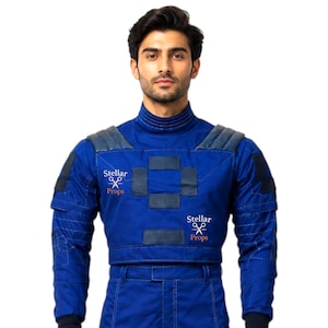 May include: A blue costume with padded shoulders and a cropped top. The costume has dark blue accents and the text "Stellar Props" is visible. The outfit appears to be a futuristic or sci-fi themed garment.