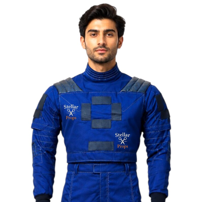 May include: A blue costume with padded shoulders and a cropped top. The costume has dark blue accents and the text "Stellar Props" is visible. The outfit appears to be a futuristic or sci-fi themed garment.