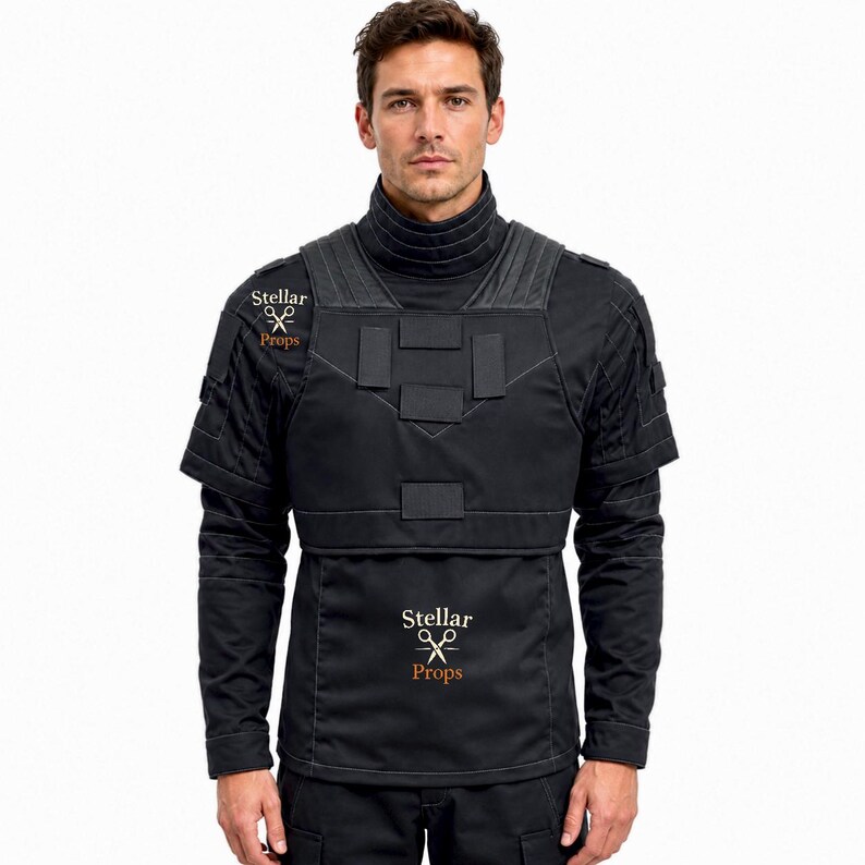 May include: A black tactical-style long-sleeve shirt featuring a high ribbed collar, a structured chest panel with rectangular patches, and short sleeves layered over long sleeves. The garment displays the text Stellar Props with scissors.