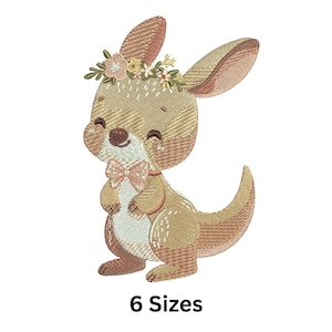 May include: Embroidered design of a cute kangaroo with a floral crown and a pink bow tie. The kangaroo is brown and beige with a light blue belly. The design is perfect for embroidery projects.